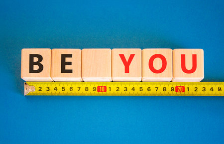 Be you support and help symbol. Concept word Be you on beautiful wooden blocks. Beautiful blue background. Beautiful yellow tape measure ruler. Business be you support and help concept. Copy space.の写真素材