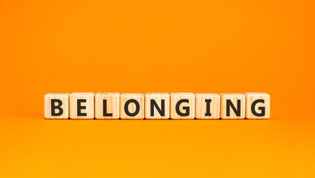 Belonging symbol. Concept words Belonging on beautiful wooden blocks. Beautiful orange background. Business support belonging concept. Copy space.の写真素材