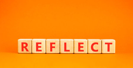 Reflect word symbol. Concept word Reflect on beautiful wooden blocks. Beautiful orange background. Business psychological reflect word concept. Copy space.の写真素材