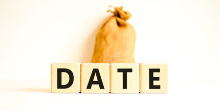 Date symbol. Concept word Date on beautiful wooden blocks. Beautiful canvas bag. Beautiful white table white background. Business and date concept. Copy space.の写真素材