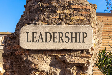 Leadership symbol. Concept word Leadership on beautiful white marble sign plate. Beautiful ancient brick wall background. Business leadership concept. Copy space.の写真素材