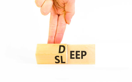 Deep sleep symbol. Concept words Deep sleep on beautiful wooden cubes. Beautiful white table white background. Doctor's hand. Healthy lifestyle, medical and deep sleep concept. Copy space.の写真素材