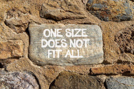 One size does not fit all symbol. Concept words One size does not fit all on beautiful gray stone. Beautiful stone wall background. Business one size does not fit all concept. Copy space.の写真素材