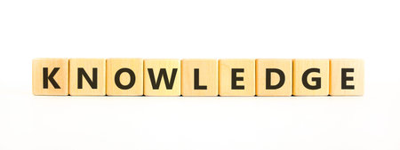 Knowledge symbol. Concept word Knowledge on beautiful wooden blocks. Beautiful white background. Business knowledge concept. Copy space.の写真素材