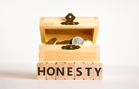 Honesty word symbol. Concept word Honesty on beautiful wooden blocks. Beautiful white background. Beautiful wooden chest with coins. Business honesty concept. Copy space.の写真素材
