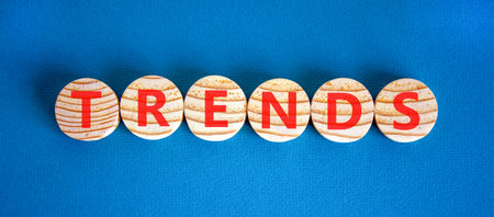 Trends trend word symbol. Concept word Trends on beautiful wooden circles. Beautiful blue background. Business trends trend word concept. Copy space.の写真素材