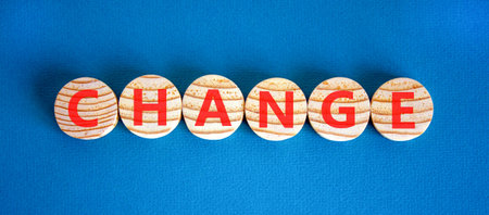 Change symbol. Concept word Change on beautiful wooden circles. Beautiful blue background. Business change concept. Copy space.の写真素材