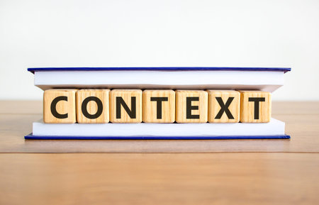 Context symbol. Concept word Context on beautiful wooden blocks in book. Beautiful wooden table white background. Business context concept. Copy space.の写真素材