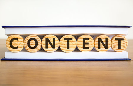 Content symbol. Concept word Content on beautiful wooden circles in book. Beautiful wooden table white background. Business content concept. Copy space.の写真素材