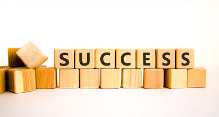 Successful success symbol. Concept word Success on beautiful wooden blocks. Beautiful white...