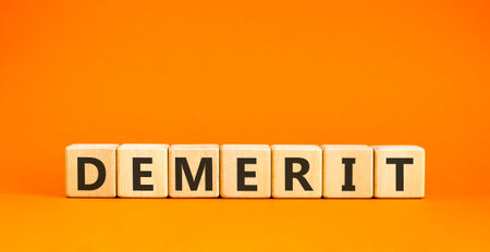 Demerit symbol. Concept word Demerit on beautiful wooden blocks. Beautiful orange background. Business demerit concept. Copy space.の写真素材