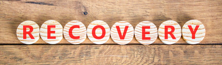 Recovery word symbol. Concept word Recovery on beautiful wooden circles. Beautiful wooden background. Business medical support help recovery word concept. Copy space.の写真素材