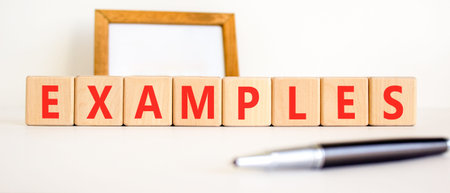 Example examples symbol. Concept word Examples on beautiful wooden blocks. Beautiful white...