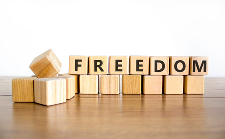 Freedom support symbol. Concept word Freedom on beautiful wooden blocks. Beautiful wooden table...