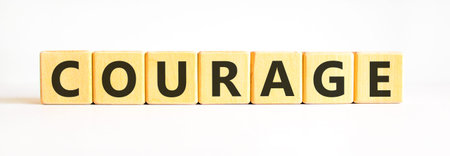 Courage symbol. Concept word Courage on beautiful wooden blocks. Beautiful white background....
