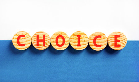 Choice symbol. Concept word Choice on beautiful wooden circles. Beautiful blue and white background. Business choice concept. Copy space.の写真素材