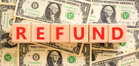 Refund word symbol. Concept word Refund on beautiful wooden blocks. Beautiful dollar bills...