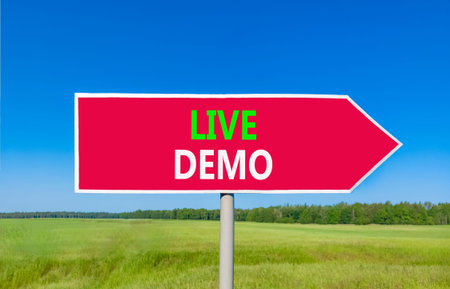 Live demo symbol. Concept words Live demo on beautiful red road sign. Beautiful blue sky green grass...