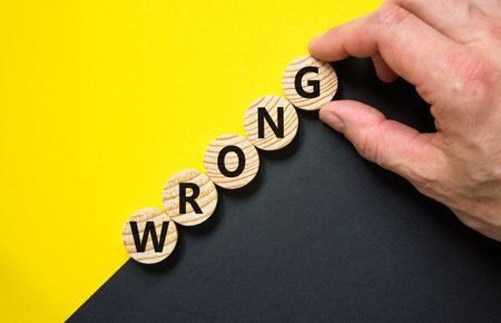 Wrong symbol. Concept word Wrong on beautiful wooden circles. Beautiful yellow and black background....