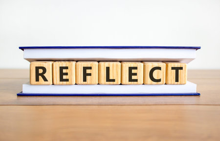 Reflect word symbol. Concept word Reflect on beautiful wooden blocks in book. Beautiful wooden table...