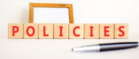 Policies word symbol. Concept word Policies on beautiful wooden blocks. Beautiful white background....