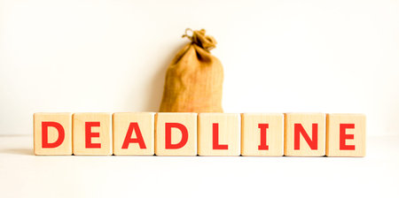Deadline word symbol. Concept word Deadline on wooden blocks. White background. Canvas bag. Business...