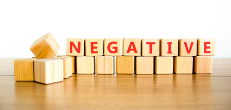 Negative word symbol. Concept word Negative on beautiful wooden blocks. Beautiful wooden table white...