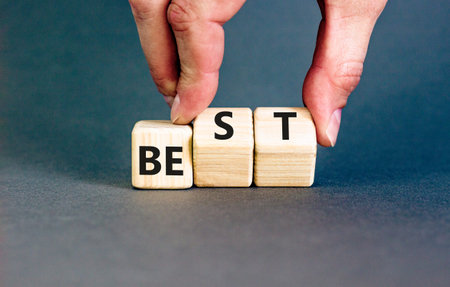Motivational and inspirational be the best symbol. Concept words Be best on beautiful wooden block. Beautiful gray background Businessman hand. Business motivational be best concept. Copy space.の写真素材