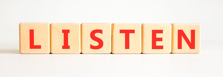 Listen symbol. Concept Listen word on beautiful wooden blocks. Beautiful white background. Business education listen concept. Copy space.の写真素材