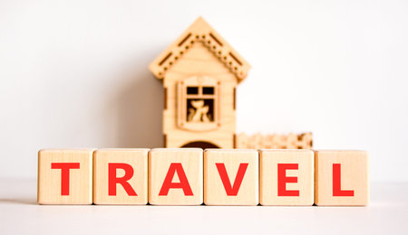 Travel traveling touristic symbol. Concept word Travel on beautiful wooden blocks. Beautiful white background. Beautiful model of house. Business travel traveling touristic word concept. Copy space.の写真素材