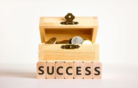 Successful success symbol. Concept word Success on beautiful wooden blocks. Beautiful white background. Beautiful wooden chest with coins. Business success or successful concept. Copy space.の写真素材