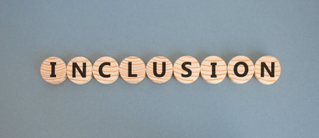 Inclusion symbol. Concept words Inclusion on beautiful wooden circles. Beautiful gray background. Business support inclusion concept. Copy space.の写真素材