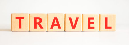 Travel traveling touristic word symbol. Concept word Travel on beautiful wooden blocks. Beautiful white background. Business travel traveling touristic word concept. Copy space.の写真素材