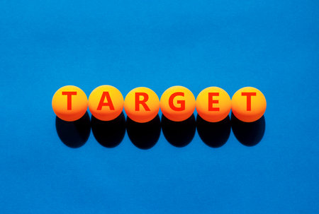 Target word symbol. Concept word Target on beautiful orange table tennis ping pong balls. Beautiful blue background. Business target word concept. Copy space.の写真素材