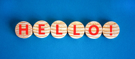 Hello welcome support and help symbol. Concept word Hello on beautiful wooden circles. Beautiful blue background. Business psychological hello support and help concept. Copy space.の写真素材