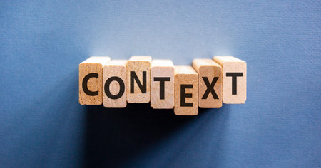 Context symbol. Concept word Context on beautiful wooden blocks. Beautiful blue background. Business context concept. Copy space.の写真素材