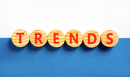 Trends trend word symbol. Concept word Trends on beautiful wooden circles. Beautiful blue and white background. Business trends trend word concept. Copy space.の写真素材
