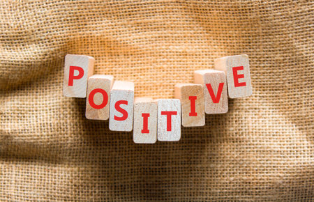 Positive word symbol. Concept word Positive on beautiful wooden blocks. Beautiful canvas background. Business support help positive word concept. Copy space.の写真素材