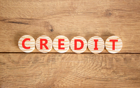 Credit symbol. Concept word Credit on beautiful wooden circles. Beautiful wooden background. Business credit concept. Copy space.の写真素材