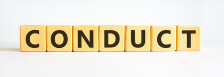 Conduct symbol. Concept word Conduct on beautiful wooden blocks. Beautiful white background. Business conduct concept. Copy space.の写真素材