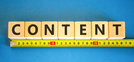 Content symbol. Concept word Content on beautiful wooden blocks. Beautiful blue background. Beautiful yellow ruler. Business content concept. Copy space.の写真素材