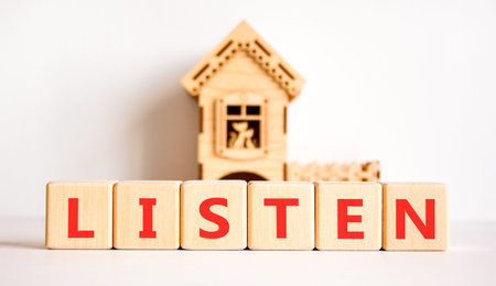 Listen symbol. Concept Listen word on beautiful wooden blocks. Beautiful white background. Beautiful wooden model of house. Business education listen concept. Copy space.の写真素材