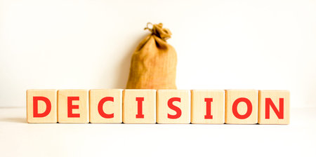 Decision word symbol. Concept word Decision on beautiful wooden blocks. Beautiful white background. Beautiful canvas bag. Business support help decision word concept. Copy space.の写真素材