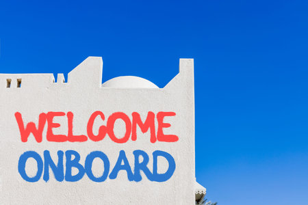 Welcome onboard symbol. Concept words Welcome onboard on beautiful white wall. Beautiful white wall and blue sky background. Business, motivational welcome onboard concept. Copy space.の写真素材