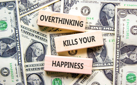 Overthinking kills your happiness symbol. Concept words Overthinking kills your happiness on wooden blocks. Beautiful dollar bills background. Business overthinking kills happiness concept. Copy spaceの写真素材