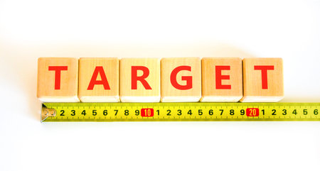 Target word symbol. Concept word Target on beautiful wooden blocks. Beautiful white background. Beautiful yellow tape measure ruler. Business target word concept. Copy space.の写真素材