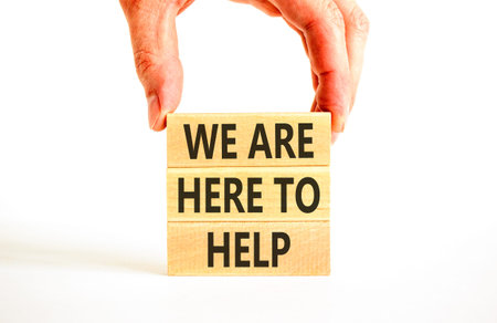 Support, help and we are here to help symbol. Concept words We are here to help on beautiful wooden blocks. Beautiful white background. Business we are here to help concept. Copy space.の写真素材