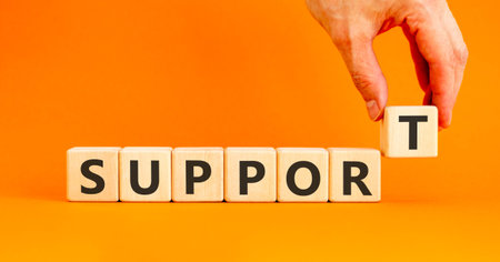Support help word symbol. Concept word Support on beautiful wooden blocks. Beautiful orange...