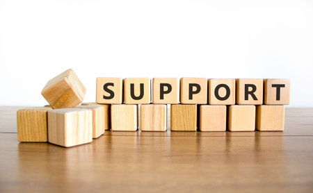 Support help word symbol. Concept word Support on beautiful wooden blocks. Beautiful wooden table...