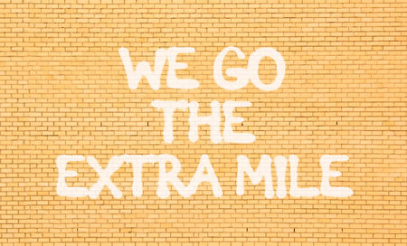 Support, help we go the extra mile symbol. Concept words We go the extra mile on beautiful brown...